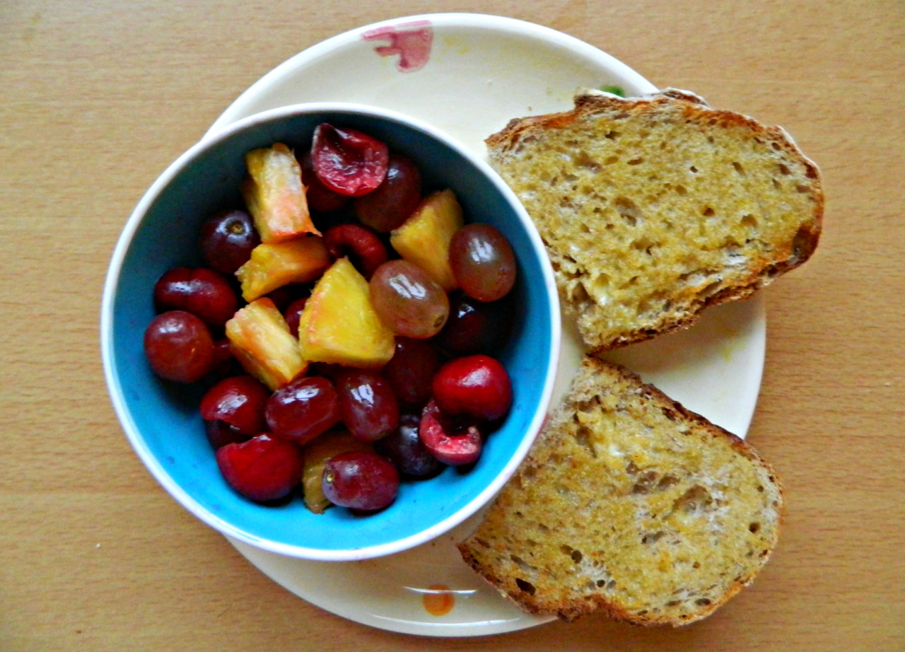 Wholewheat sourdough toast with sunflower ‘butter’ and fruit salad - pineapple, red grapes, cherries.