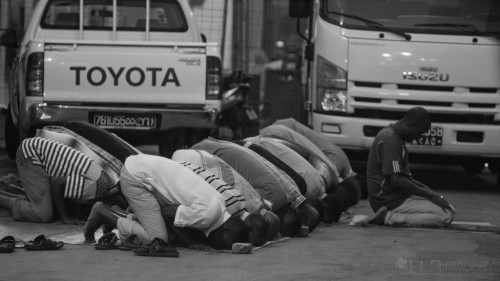 Men praying on the street in Djibouti