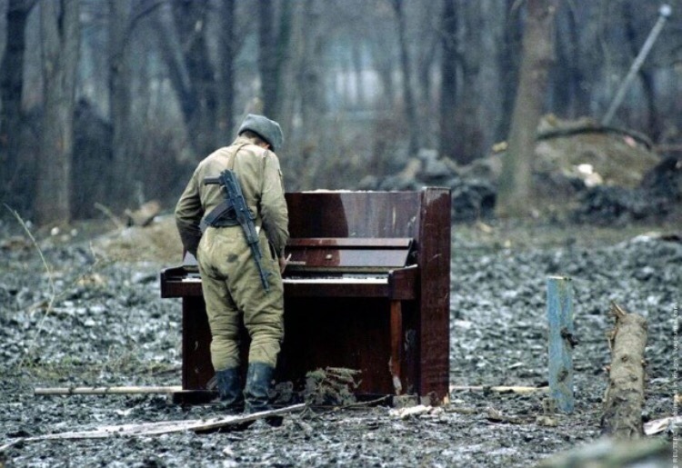 badertwj:  Russian soldier playing an abandoned piano, Chechnya, c. 1994 