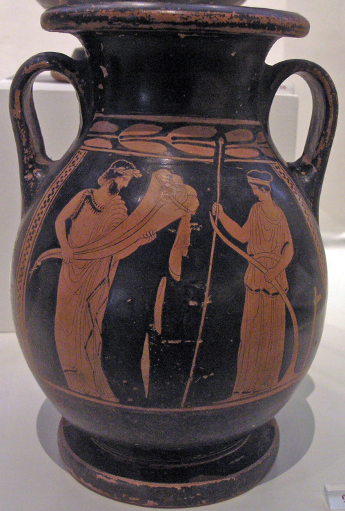 Plouton, god of wealth, holds a cornucopia, opposite Demeter, who holds a scepter and plough.  