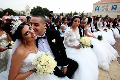 biladal-sham: Bkerke, Lebanon. A groom kisses his bride as Lebanese Maronite Christian couples take 