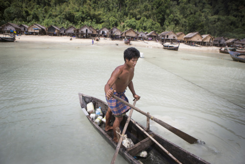 Nguy, an indigenous Moken man living on Ko Surin island, rows his small sampan out into the shallow 