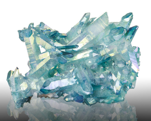 fuckyeahmineralogy:  Aqua Aura Quartz; Arkansas Like Rainbow Aura Quartz, Aqua Aura Quartz is an artificially enhanced crystal—in this case, it is bonded with a coating of gold.