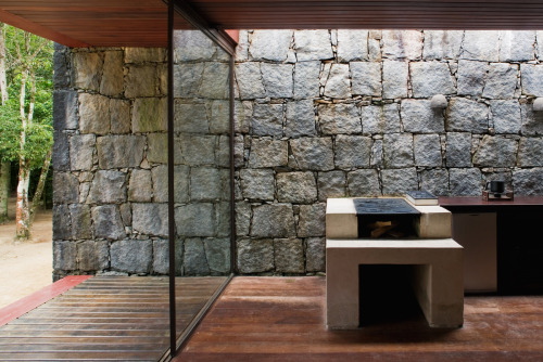 letsbuildahome-fr:  House in Rio Bonito by Carla Juaçaba Four steel beams puncture walls so as to allow a sliver of glazing to wash the interior of the stone walls with diffused light. The visual weight of the rustic stone counters the lightness of