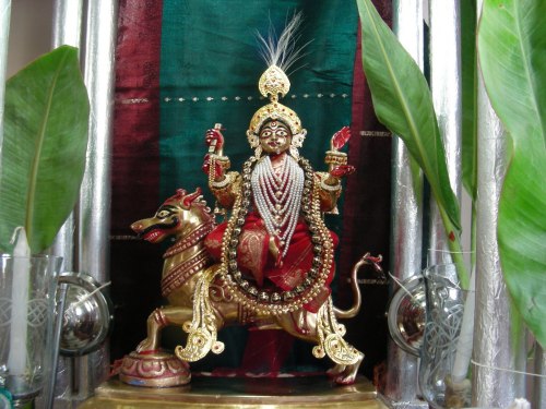 The domestic altar is the heart of a Hindu home, the Goddess Chandi in this photo appears in a conte