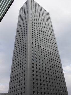 architectureland:  Jardine House  - Palmer &amp; Turner The building is constructed with a metal frame, and a curtain wall with round windows. The thickness of the structural frame is reduced because of the shape of the windows. Unusually for a Jardine