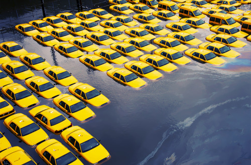 Photo by Charles Sykes   |   Hoboken, NJ   |   October 30, 2012 A parking lot full of yellow cabs is