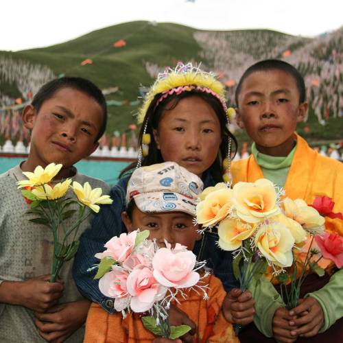 global-musings:  Tibetan children offering artificial flowers at a Buddhist festival in the grasslan