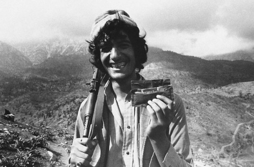 A Muslim guerrilla inPaktia Province shows off his combat ration of peanut butter from theU.S. (Afgh