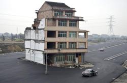 jakemorph:  furtho: In the middle of a new highway, a house owned by an elderly couple who refused to sign an agreement allowing it to be demolished, Wenling, China, 2012 (via here) 