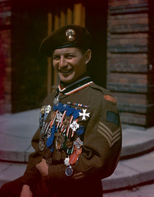 Sgt G. Durocher of the Les Fusiliers Mont-Royal poses with his 29 souvenir medals