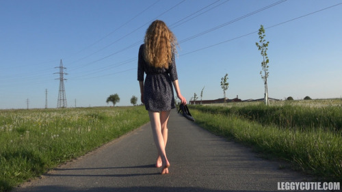 Young girl walking barefoot on the road. Download the video: leggycutie.com