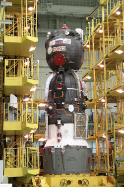 humanoidhistory:  Kazakhstan, May 8, 2012. At the Baikonur Cosmodrome, the Soyuz TMA-04M spacecraft is prepared to be inserted into the Soyuz booster upper stage rocket before launch. (NASA: 1, 2)