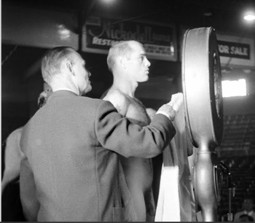 notdbd:  Boxer Carl “Bobo” Olson takes off all his clothes and weighs in before his big fight with Sugar Ray Robinson in 1956.  From the Life Magazine archives.  Check out more photos of jocks and others here.  
