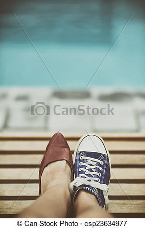 mismatched converse sneakers on legs