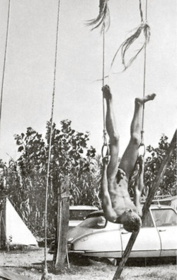 vintagemusclemen:Is this a real athlete, or is he just goofing around?  Shouldn’t he be worried about those frayed ropes?  Is that a vintage Citroen behind him?  Is this a French nudist camp where they did gymnastics?  So many questions.