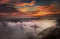 archatlas:  Foggy Budapest by Tamás RizsaviTamás Rizsavi is a Hungarian urban photographer that spent 4 years capturing the beauty of Budapest when It’s covered by fog. It is pretty rare in Budapest when the fog sits so low that the bridges and other