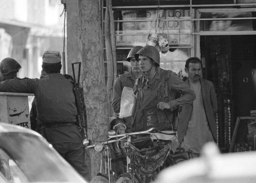 Two Soviet soldiers come out from a store in Kabul, Afghanistan, April 24th, 1984.