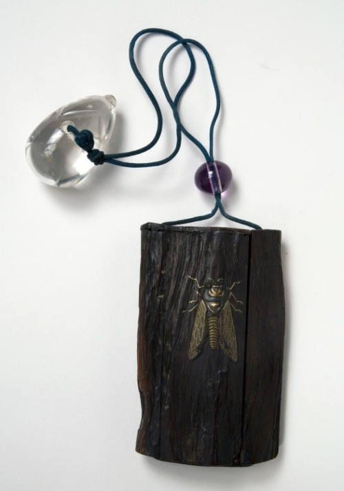 Depicting a cicada alighted on a piece of wood, the inroopens at the side to reveal five tiny drawer