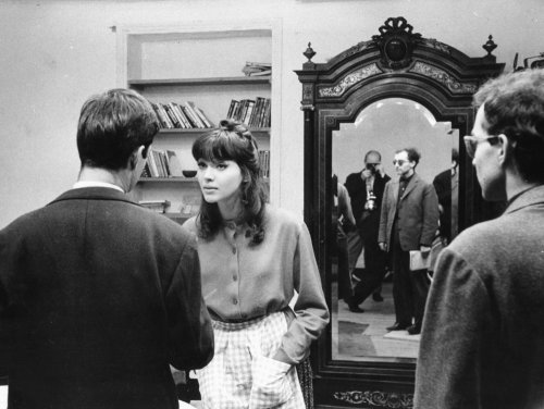 Director Jean-Luc Godard oversees a rehearsal between Jean-Paul Belmondo and Anna Karina on the set 