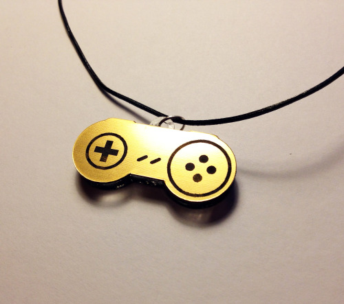 the-daily-robot:  New Laser-etched NES and SNES gamepad necklaces (in gold or silver!) available at The Daily Robot’s Etsy store!