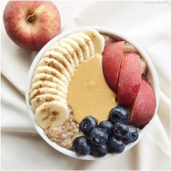 wholeandhealthy:  Cinnamon Spice porridge cooked with the juiciest peach and topped with banana, more peach, blueberries, peanut butter, and a dash of cinnamon #meals ✨  Today I am happy because I get to spend the morning cuddling with my cutest puppy