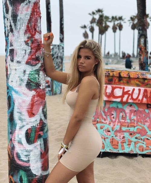 Beautiful women posing in front of graffiti