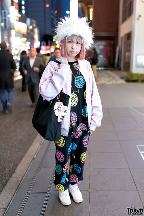 Mamina on the street in Harajuku after dark wearing a fuzzy hat with a graphic setup from Galaxxxy, 