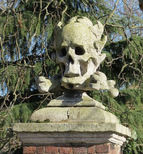 blackpaint20:   Entrance to St Nicholas Chuchyard, and carved skull.   Deptford Church of St Nichola