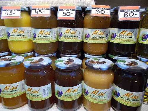 Some merchandise in bottles & jars (honey) offered during Christmas market 2021 in the city Wroc