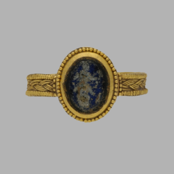 gemma-antiqua: Ancient Roman gold and blue stone ring, dated to the 1st to 2nd century CE. The stone has been carved with an intaglio of a soldier holding a spear. Images from Berganza Ltd and edited by me.