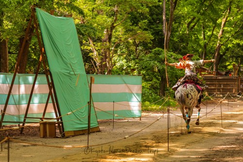 The riders are fully dressed as samurai warriors during the Yabusame Shinji. They wear a costume com