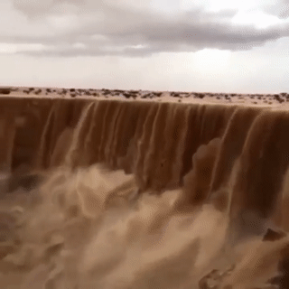 sixpenceee:A sandfall! This is amazing. What might be going on is when it rains in the desert the water isn’t absorbed quickly and mixes with the top layer of wet sand which can form moving sand rivers and waterfalls. (Source)