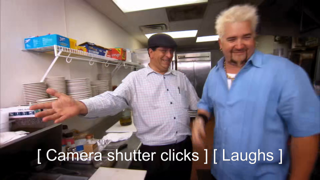 82% sure it's Guy Fieri standing in a kitchen preparing food. Caption: [ Camera shutter clicks ] [ Laughs ]