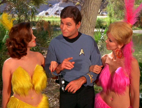 spockshair: startrekhugs: [Image: Scantily-clad young women cling to Dr McCoy and Spock. McCoy looks