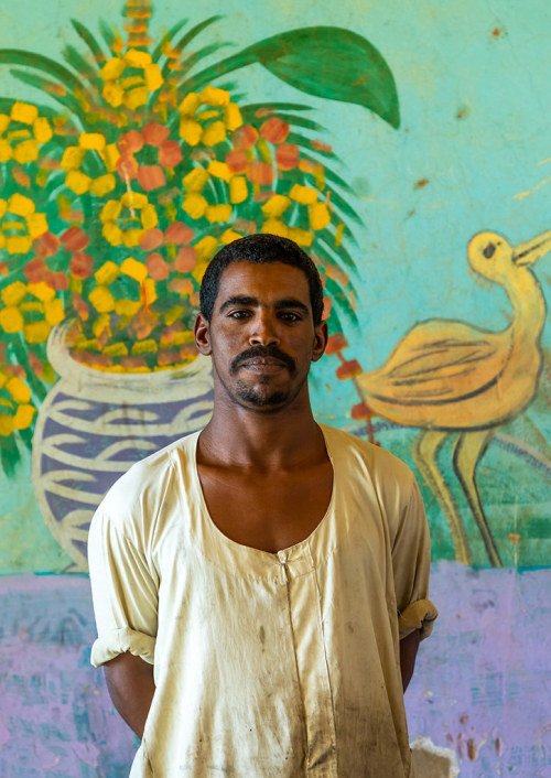 androphilia:Sudanese man in a restaurant with decorated walls, Khartoum State, Khartoum, Sudan by Ér