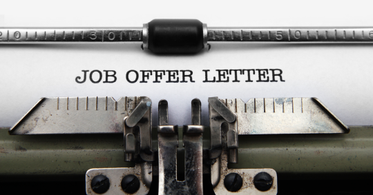 Image of typewriter with a job offer letter