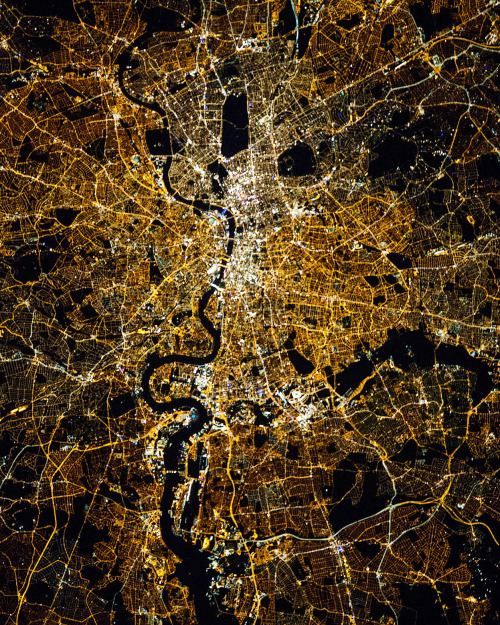 dailyoverview:London at night with the River Thames visible through its center. As the capital and m