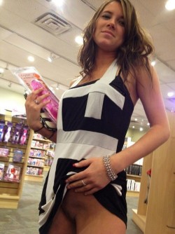 cheating-slut-wives:  Dildo shopping at the porn shop and flashing her cunt proving she didn’t wear any panties today!