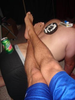 dirtykinkypigs:  faggland:  Holding the feet of a Superior is one of the best jobs a fag can do. This one is blessed to also be a table for the Man’s stuff.  Looks like that Dew is about to fall. Faggot better be careful if it doesn’t want a beating.