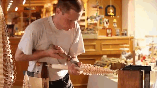 mentalflossr: Watch This Craftsman Turn Sticks of Wood Into Christmas Tree Sculptures