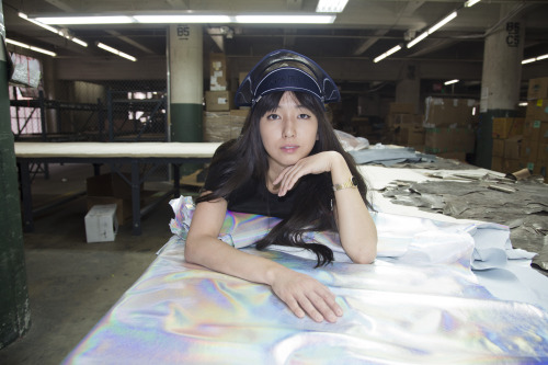 americanapparel: Kyung examining holographic fabric, March 2014.