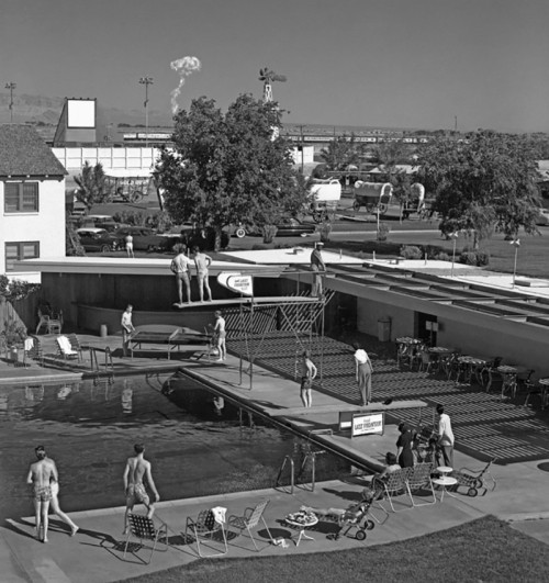 atomic-flash:  Covered Wagons & A Mushroom Cloud - Early morning bathers in Las Vegas watch a mushroom cloud from an atomic test just 75 miles away, 1953. 