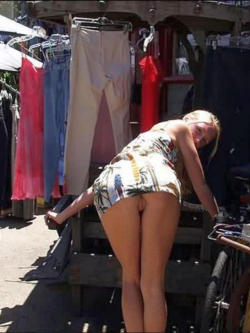 carelessinpublic:  Bending outside a shop in a short dress and showing her pussy