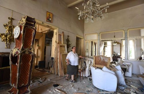 A woman in her damaged house in Beirut in the aftermath of the massive explosion from August 4, 2020