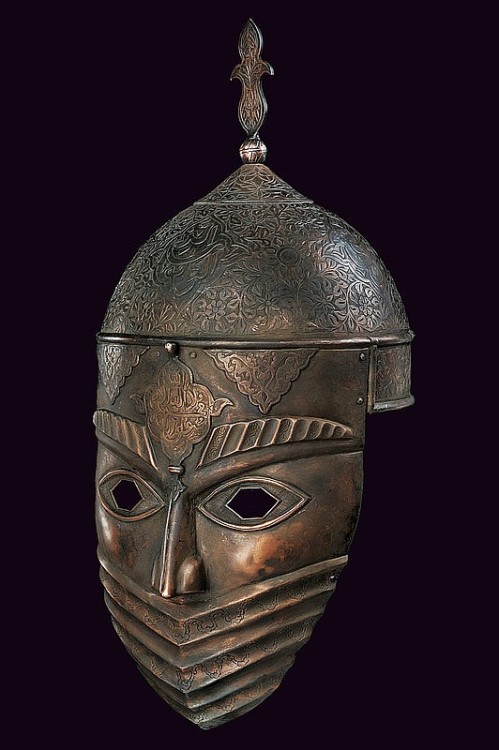 A copper covered iron war mask and helmet originating from Persia, early 19th century.