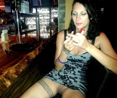 carelessinpublic:  In a short dress inside a bar and showing her pussy