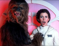 Chewbacca (Peter Mayhew) grabs a boob of Princess Leia (Carrie