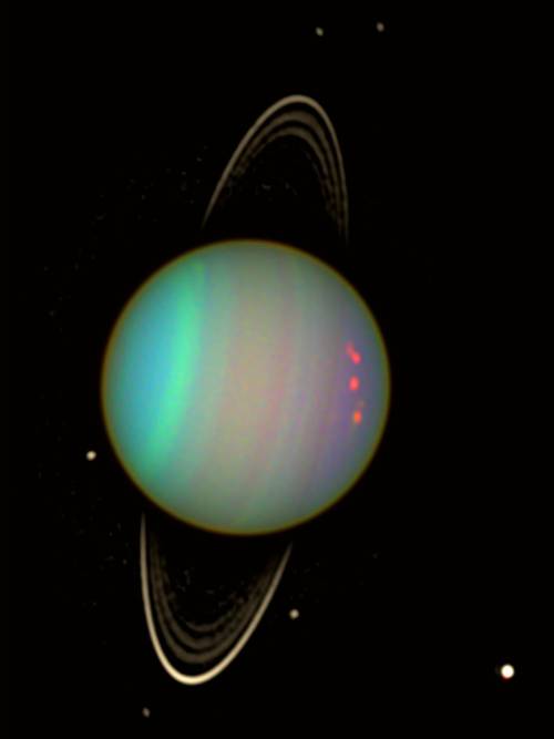 NASA, AFP/Getty Images - Two small dark moons might be hiding in the rings of Uranus, according to a