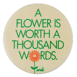 a white pin with green text that reads 'A FLOWER IS WORTH A THOUSAND WORDS.' the O in WORDS is replaced with a red flower